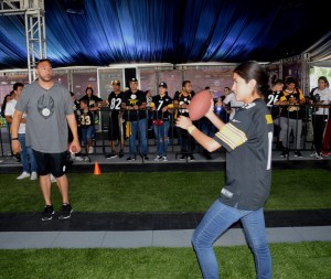 El ex quarterback Charlie Batch (izquierda) viendo a una aficionada lanzar el ovoide. Foto: Sixto López Casa Madrid.